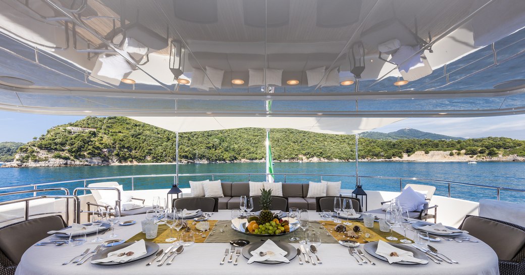 table laid for lunch on aft upper deck of superyacht FERDY 