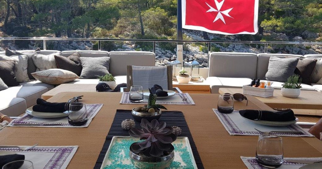 al fresco dining table on the upper deck aft of superyacht AWOL