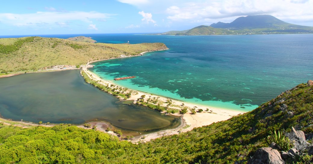 view of beach from hillside in nevis on a nevis luxury yacht charter