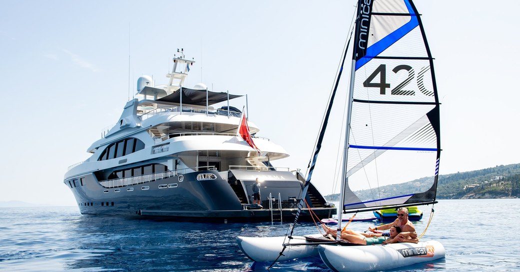 Superyacht ARBEMA in background and water tender in foreground on calm sea