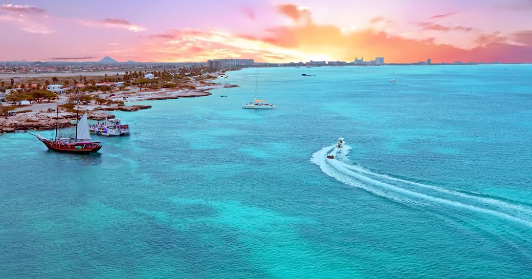 Aerial view from Aruba island in the Caribbean Sea at sunset with yachts on the water