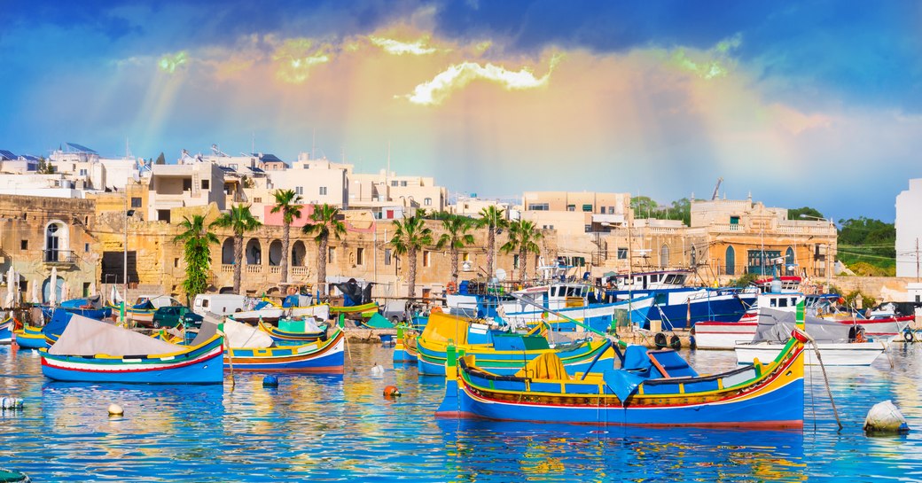 blue boats on the water in harbour in malta