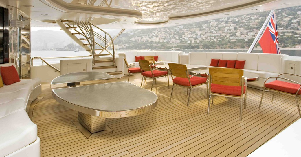 An al fresco dining table and seating arrangement on the exterior of luxury yacht 'Lady S'