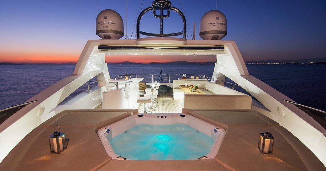 The Jacuzzi surrounded by sunpads on board superyacht PATHOS