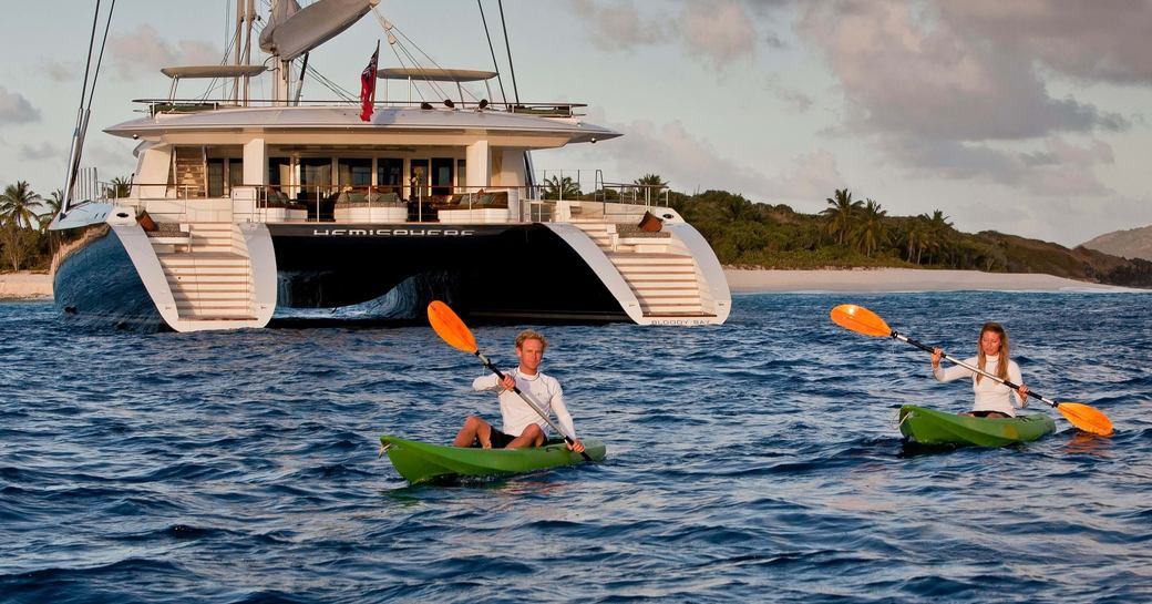 Charter guests using kayaks adjacent to charter yacht HEMISPHERE