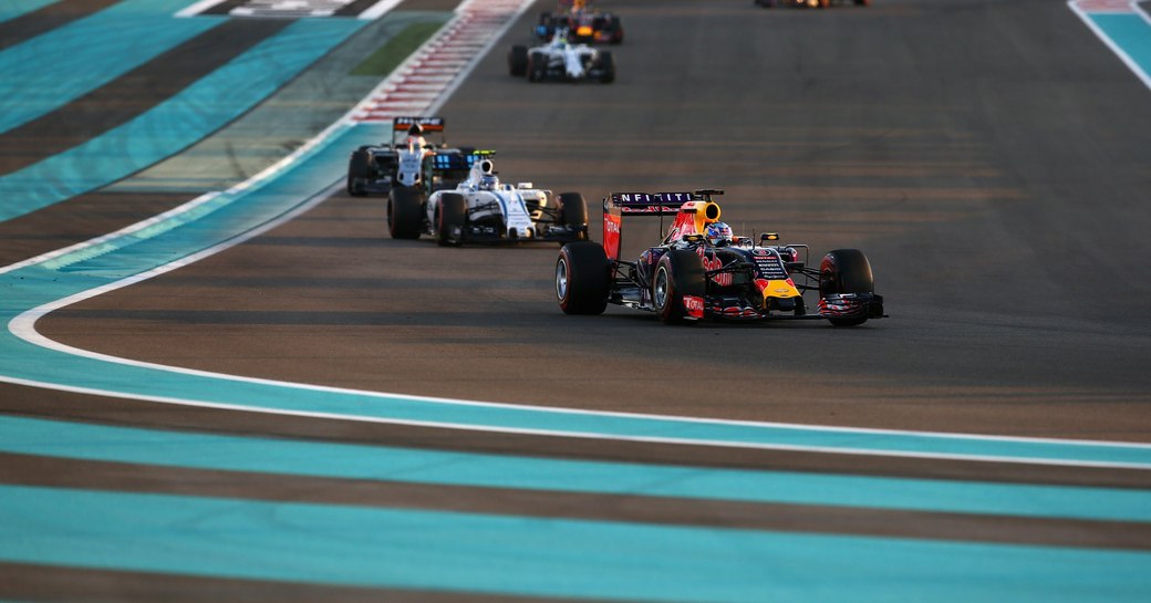 Car in the lead as it rounds the corner of the racetrack during Abu Dhabi Grand Prix with blue lines on the ground