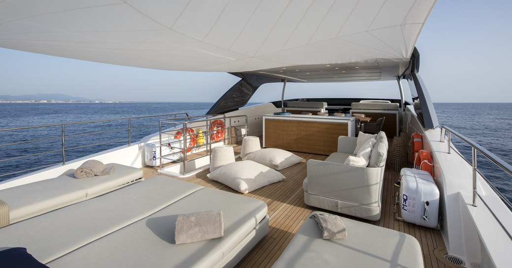 sunbeds and seating area on the aft section of the sundeck of motor yacht DINAIA 