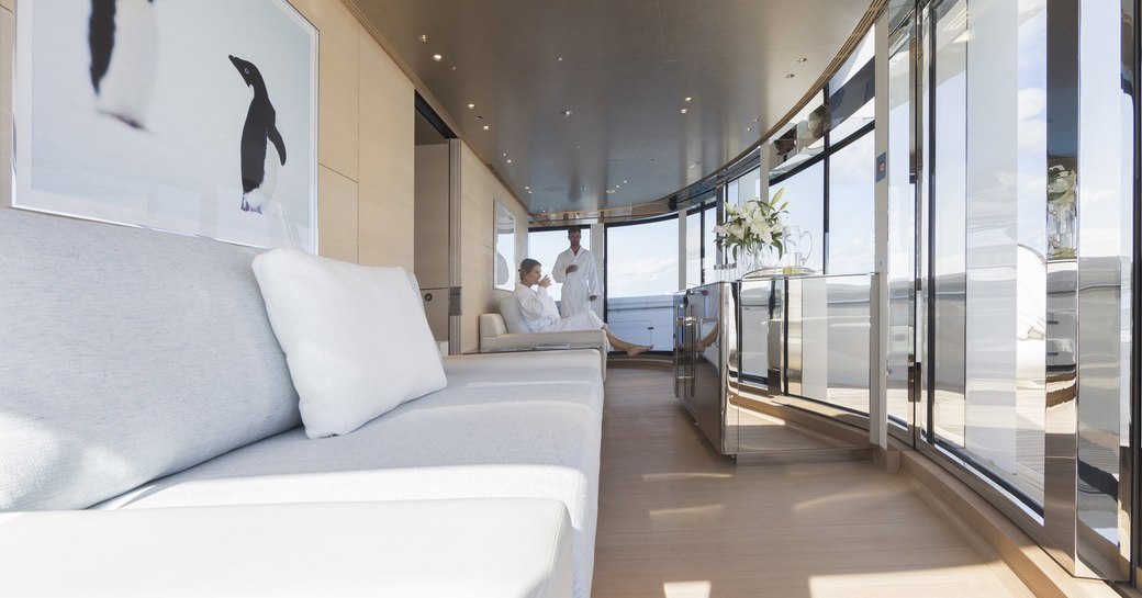 guests in dressing gowns relax in the observation salon aboard superyacht NAUTILUS 