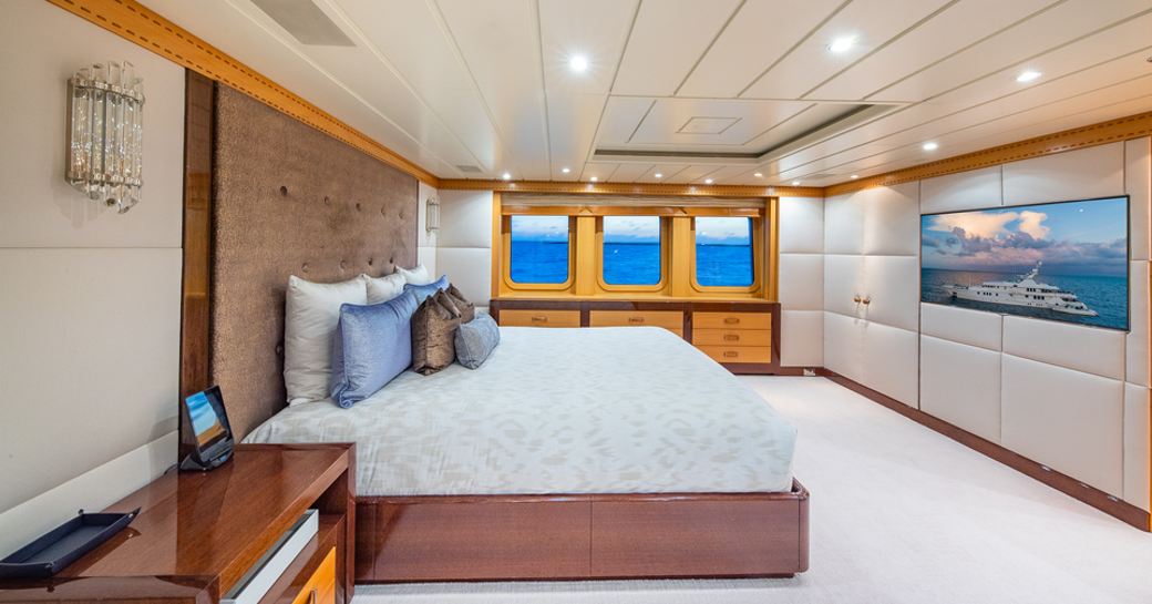 Overview of master cabin onboard yacht rental NITA K II, with central berth and three windows aft