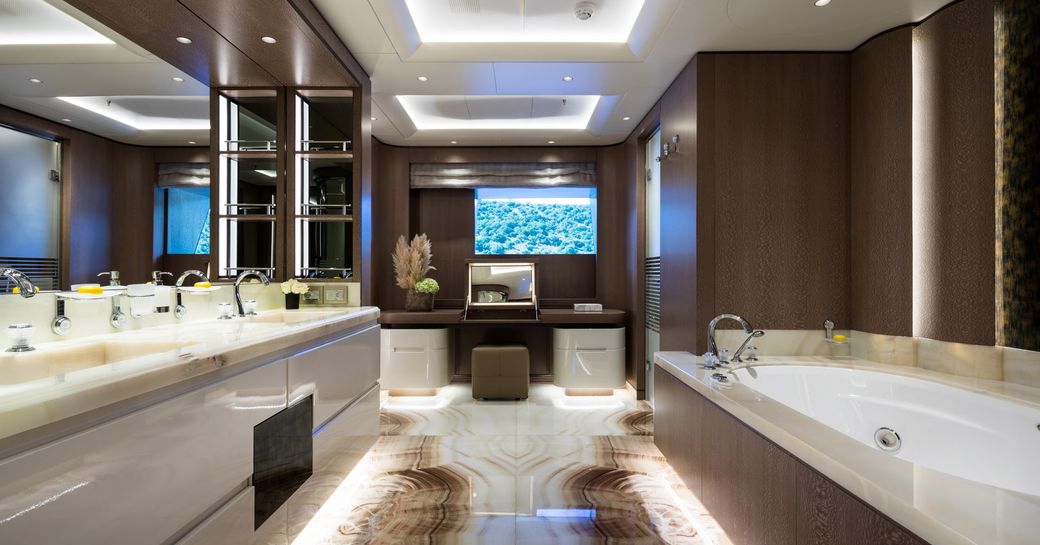 Luxury ensuite with marble effect sink and bathtub on superyacht O'PARI