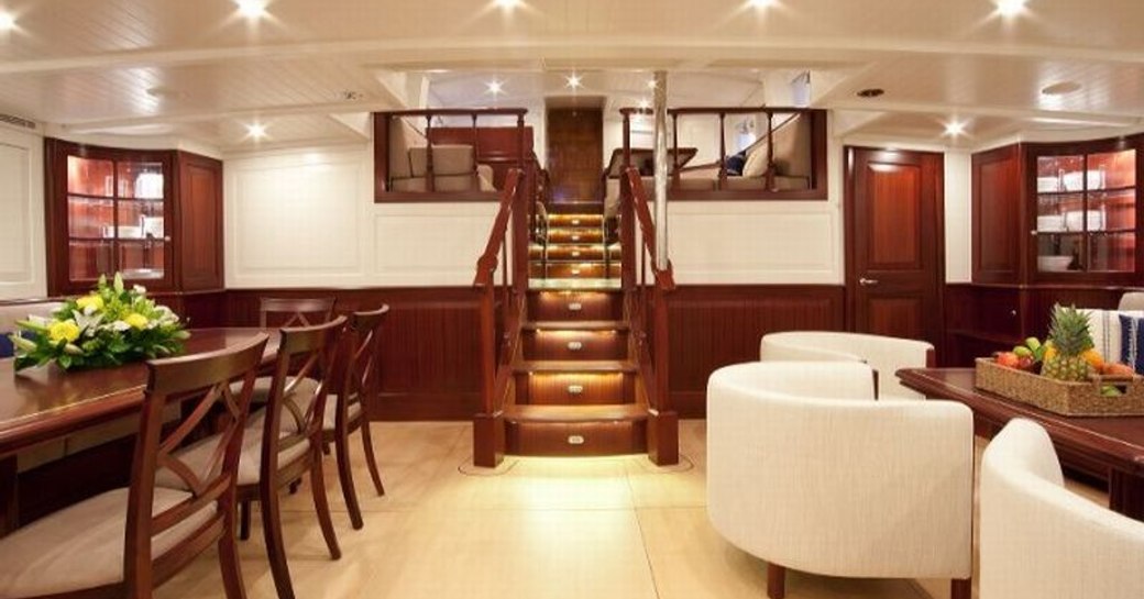 Sailing yacht Aurelius 111 main salon with steps and dining 