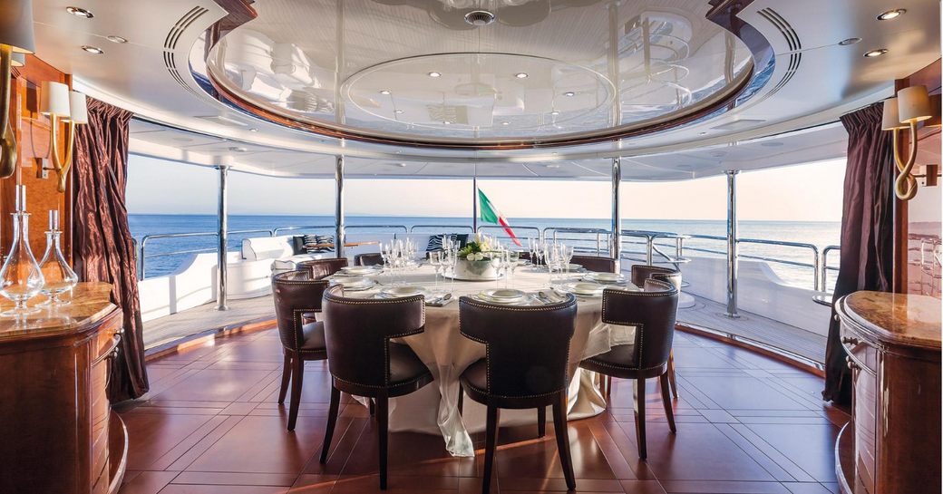 magnificent semi-alfresco dining area on the upper deck aft of motor yacht CHECKMATE 