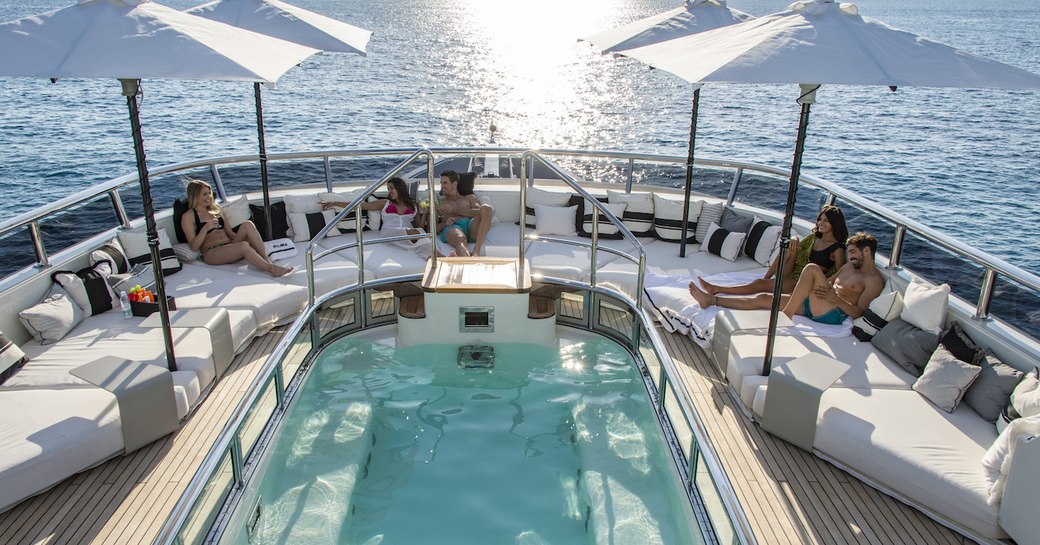 Charter guests sunbathing on Roma yacht sundeck in France