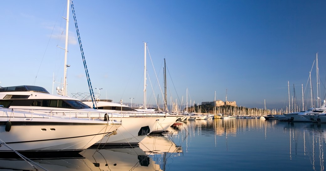 suepryachts line up in calm waters of Nice on the French Riviera