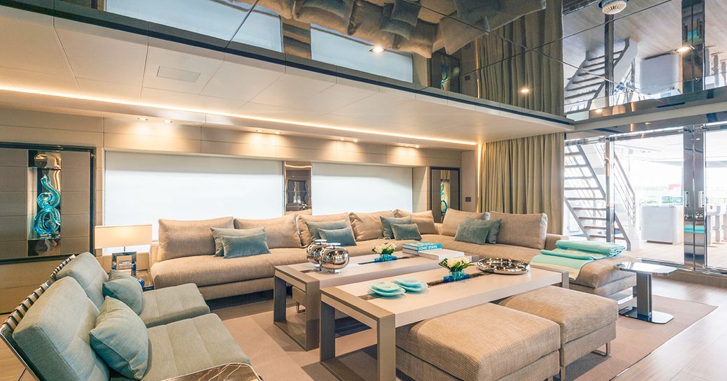 main salon on luxury superyacht utopia iv, with blue and gray furniture