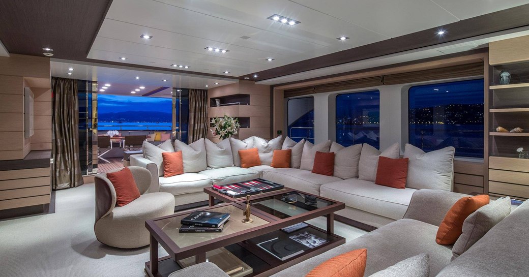 large L-shaped sofa in the main salon aboard superyacht DYNAR 