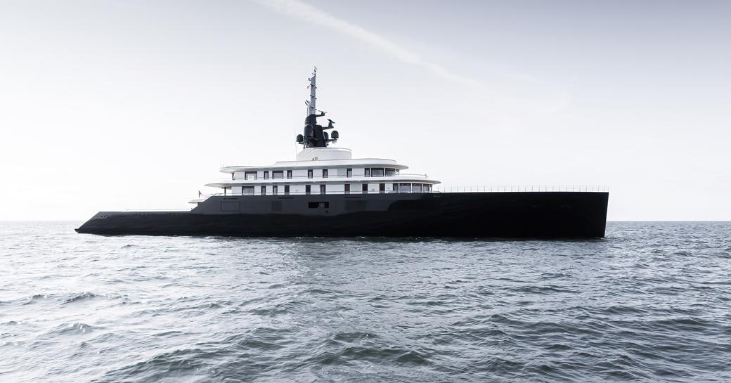 Side view of charter yacht LIVA° anchored at sea.