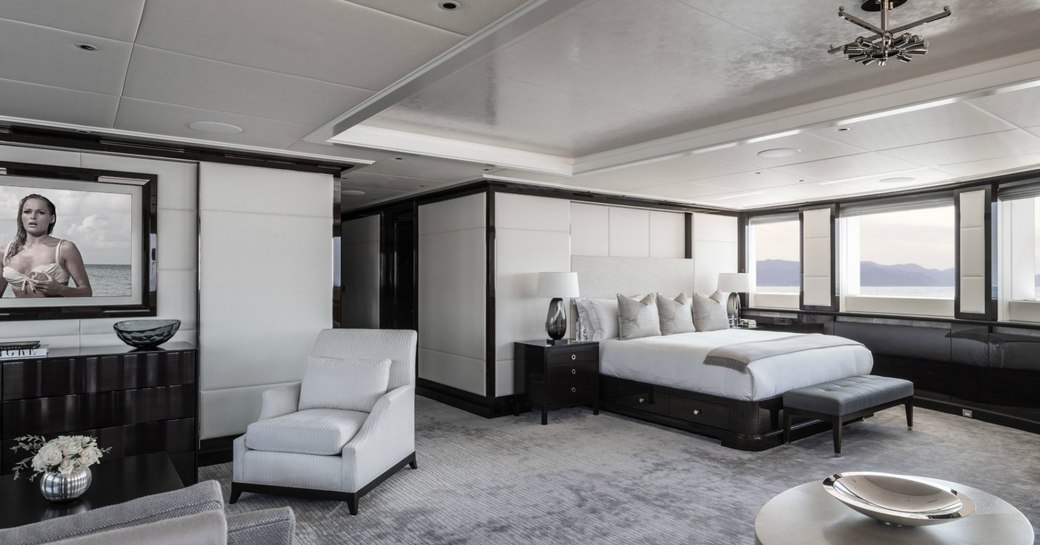 main suite superyacht aquila with grey carpet and white furniture