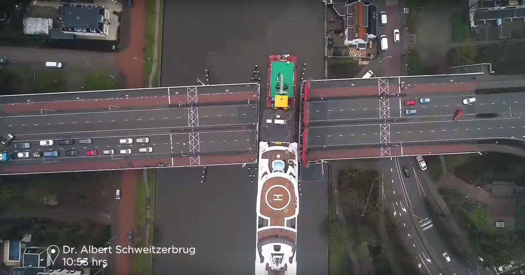 Charter yacht Lady fits through tight gap on bridge in waterway in Holland