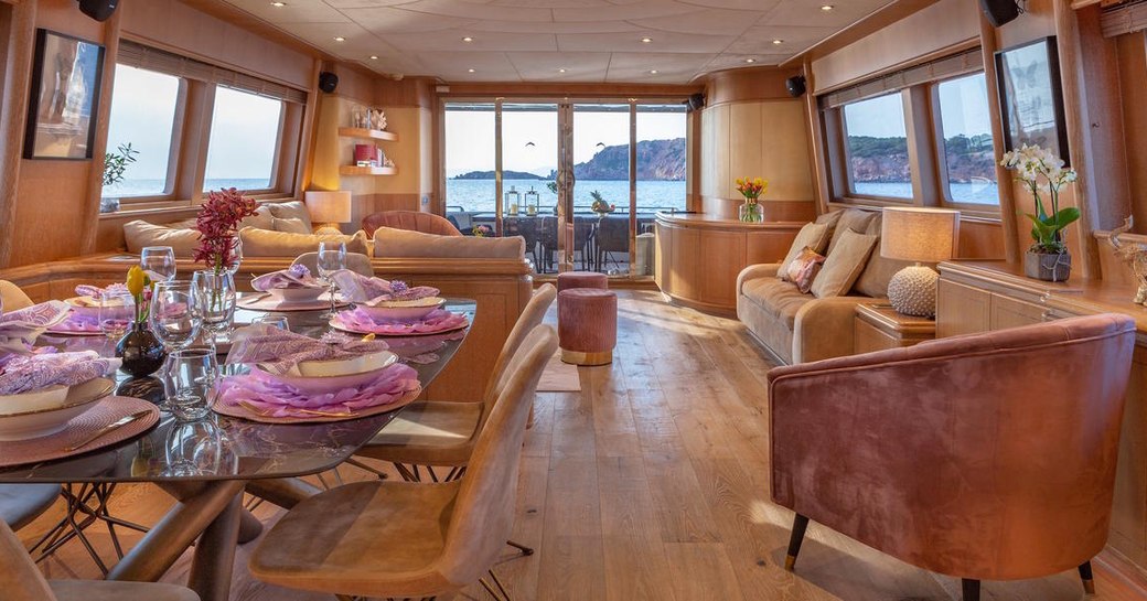 open plan Alcantara salon in luxury charter yacht ANAMEL