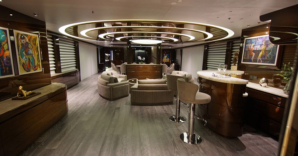 main salon on baba's yacht with marble bar and circular sofa seating