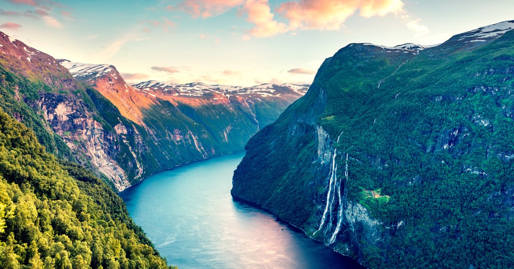 aerial shot of fjord in norway, with waterfall