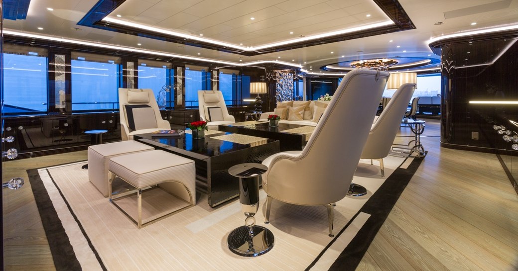 dark woods and pale upholstery in main salon aboard superyacht OKTO