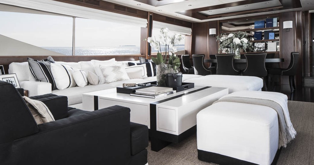 sumptuous sofa and armchair in the main salon seating area aboard luxury yacht CRISTOBAL 