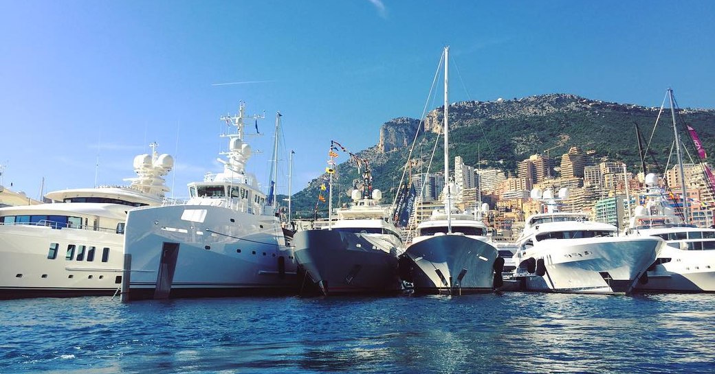 The bows of six luxury yachts lined up in Port Hercules for the Monaco Yacht Show 2017