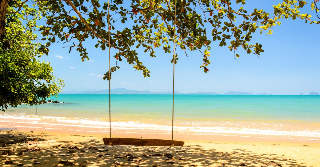 Wooden swing with turqoise sea in Thailand