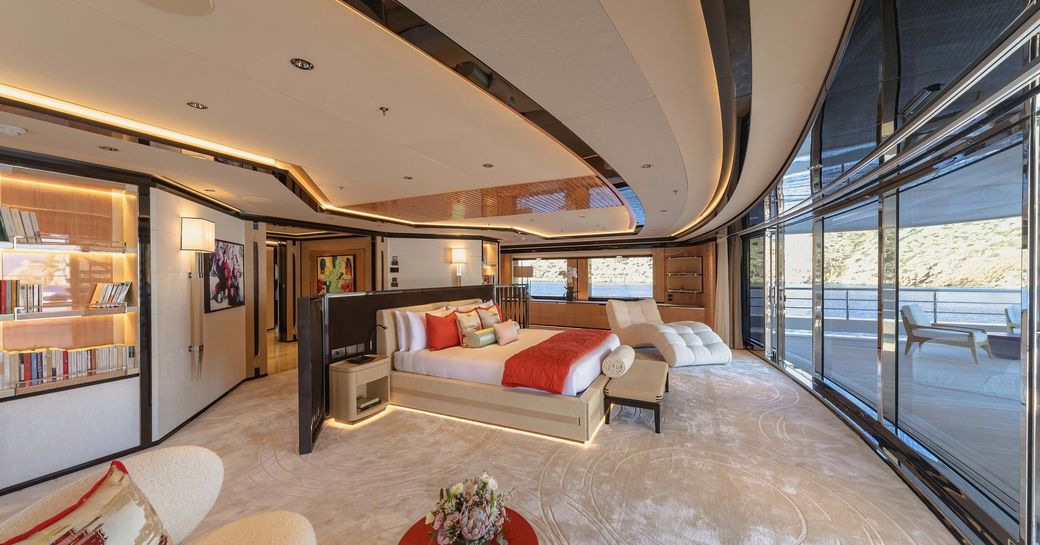 Master cabin with central berth and large windows surrounding onboard charter yacht PROJECT X