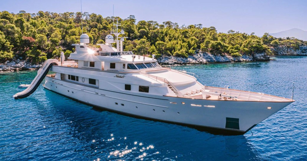 Charter yacht NATALIA V at anchor with a water slide attached