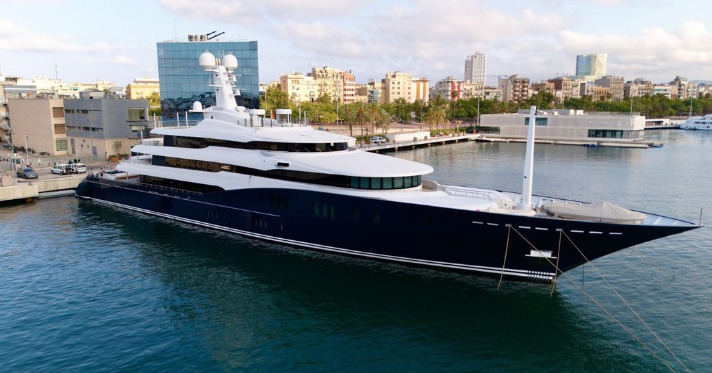 Charter yacht HBC berthed in front of cosmopolitan skyline