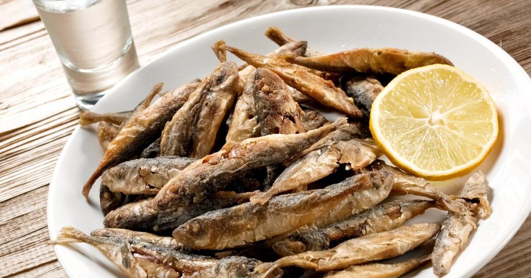 μαρίδες Fried small fishes with lemon and a glass of ouzo