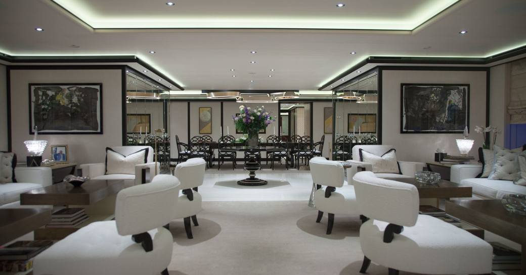 Overview of main salon with white seating onboard charter yacht PLAN B