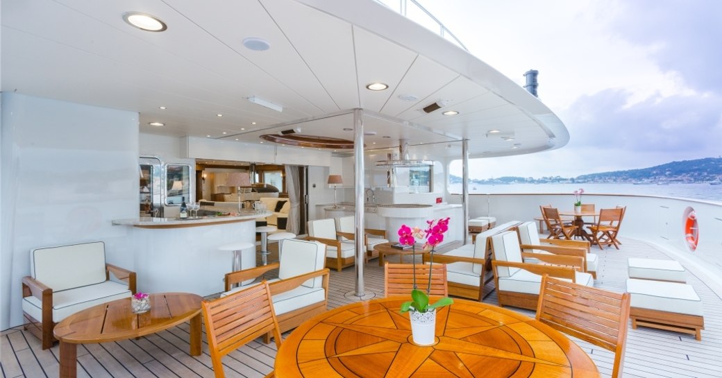 chairs, tables and bar on the upper deck aft of expedition yacht LEGEND