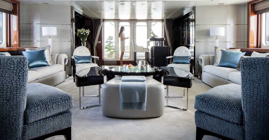 A guest enjoying the main salon of superyacht TURQUOISE