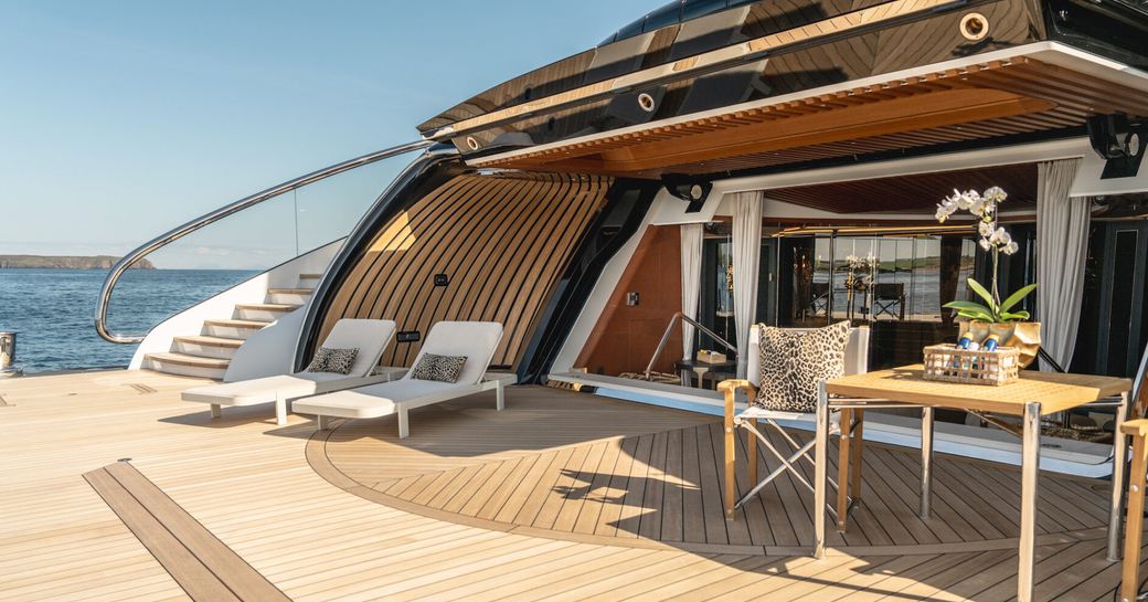Beach club entrance and swim platform with seating and loungers onboard charter yacht KISMET