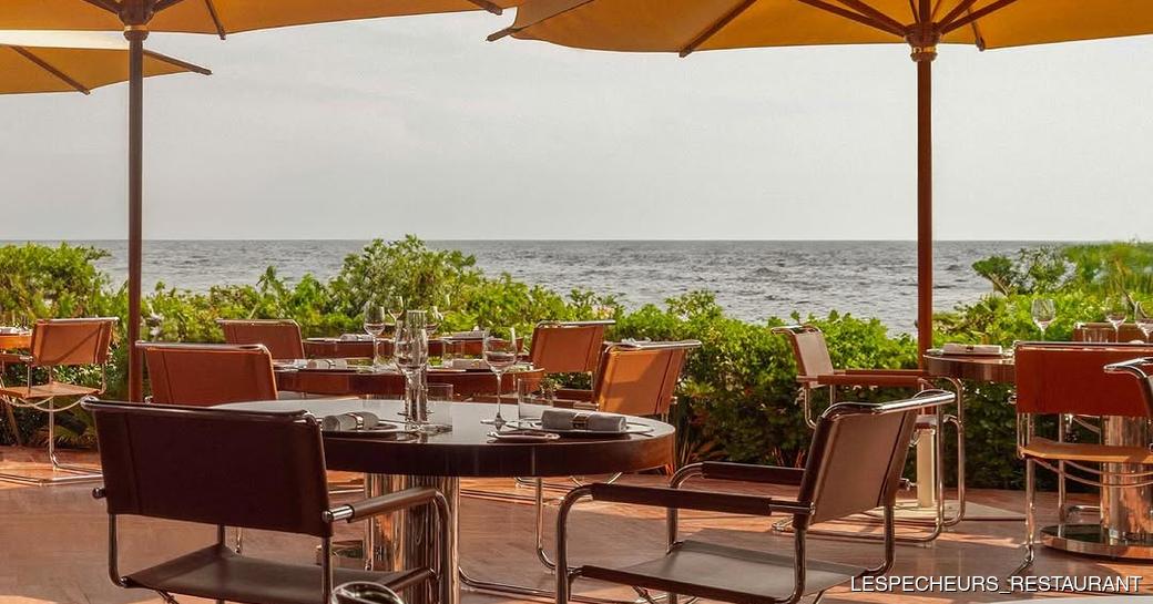 Dining tables and parasols at Les Pecheurs 