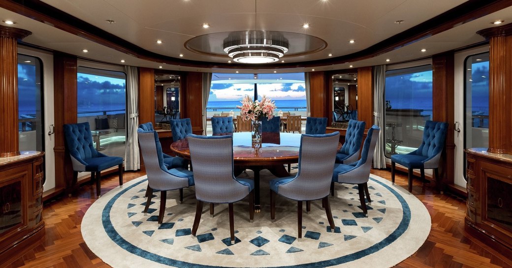 circular enclosed dining table on bridge deck aft of superyacht TITANIA 