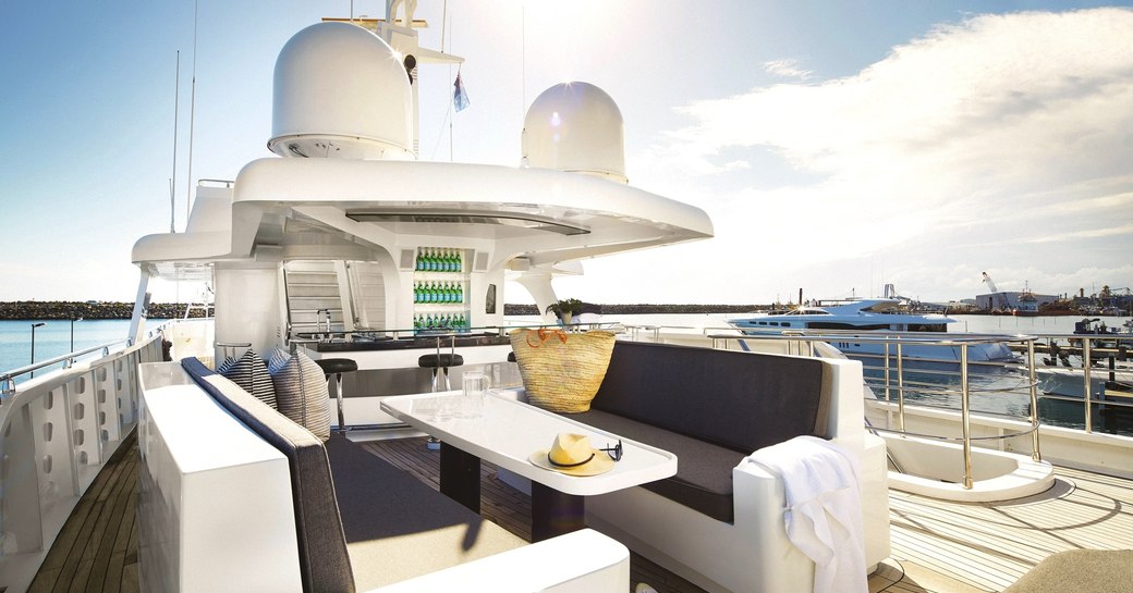 alfresco dining area and bar on sundeck of motor yacht anda