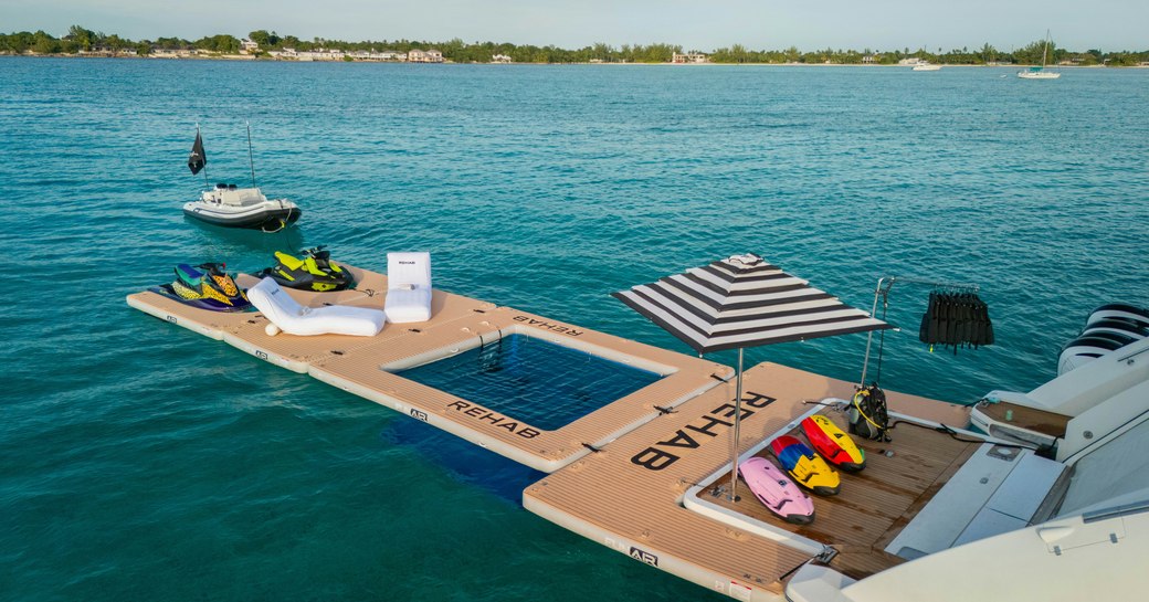 Water toys along floating platform with luxury yacht charter REHAB