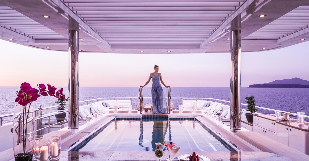 A charter guest relaxes in the pool on the sundeck of TITANIA