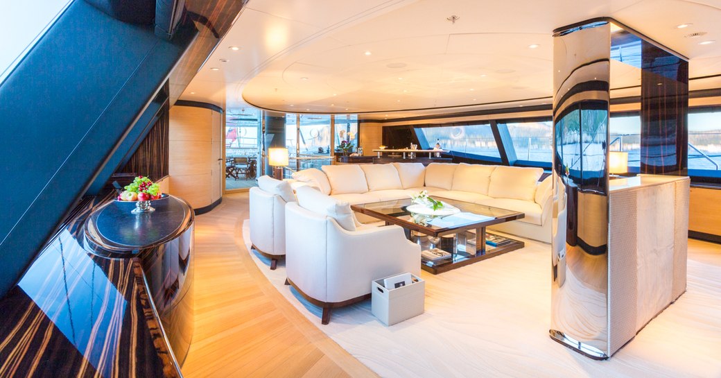 Large sofa and arm chairs forms seating area in the main salon of superyacht Q