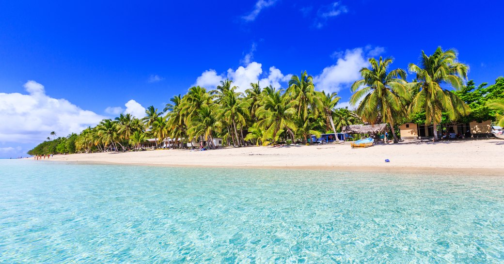 Beach on a tropical island with clear blue water. Dravuni Island, Fiji.