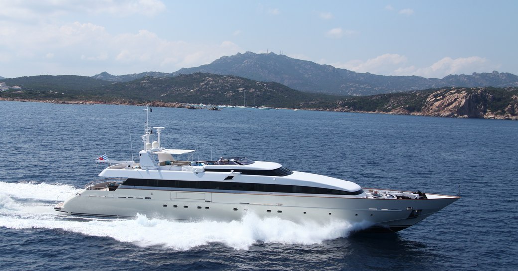 Motor yacht HEMILEA from Baglietto underway, with Mediterranean coastlines in background