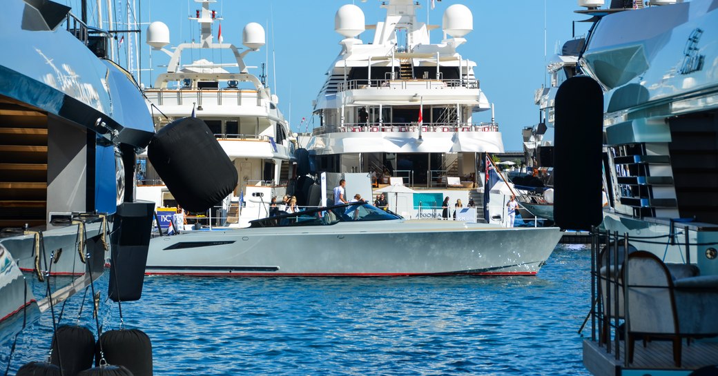 tender cruises between yachts at monaco yacht show in port hercules harbour