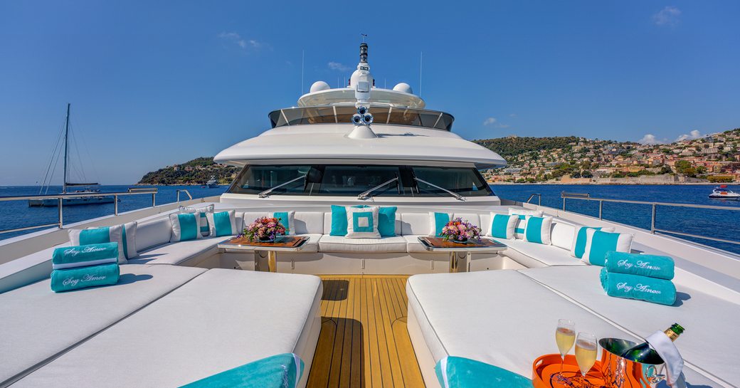 Sun pad arrangement and teal cushions onboard charter yacht NELA
