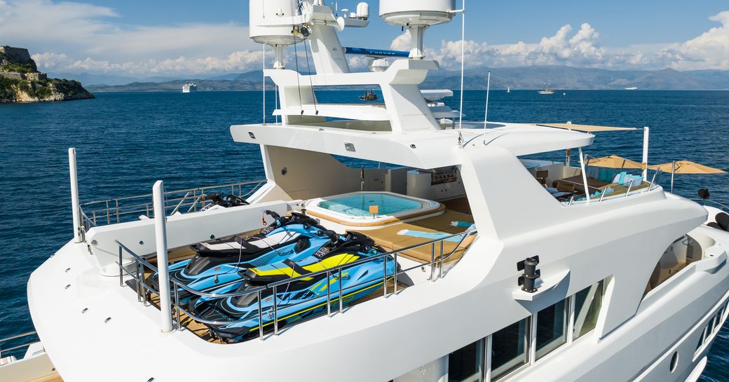 Sun deck onboard charter yacht SERENITY with a display of water toys on deck