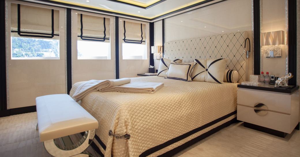 Guest cabin with double berth and three windows onboard charter yacht PLAN B